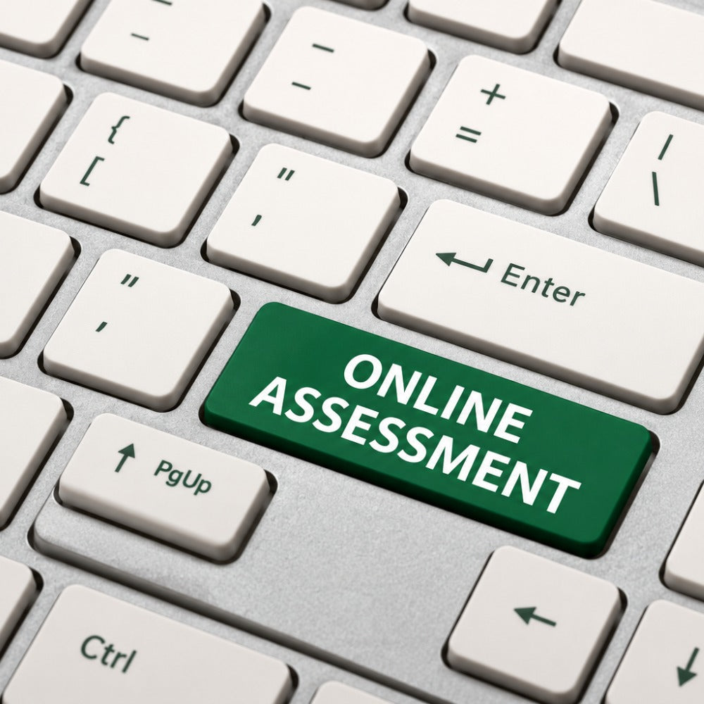 A close-up of a computer keyboard with a prominent green key labeled 'ONLINE ASSESSMENT' in white text, surrounded by standard white keys.
